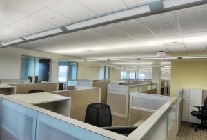 Office outfitted with multiple cubicles and office desk chairs.